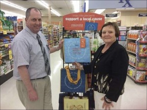 Hannaford has partnered with the Health Services Foundation for a fund¬raising event in the month of June. For every blue "Hannaford Helps" Reusable Bag sold at the Houlton location, the Health Services Foundation will receive a $1 donation to help fulfill its “Excellence in Health Care” mission. Showing off the display are, David Belyea, left, assistant manager of the Houlton Hannaford and Elizabeth Dulin, executive director for the foundation. 